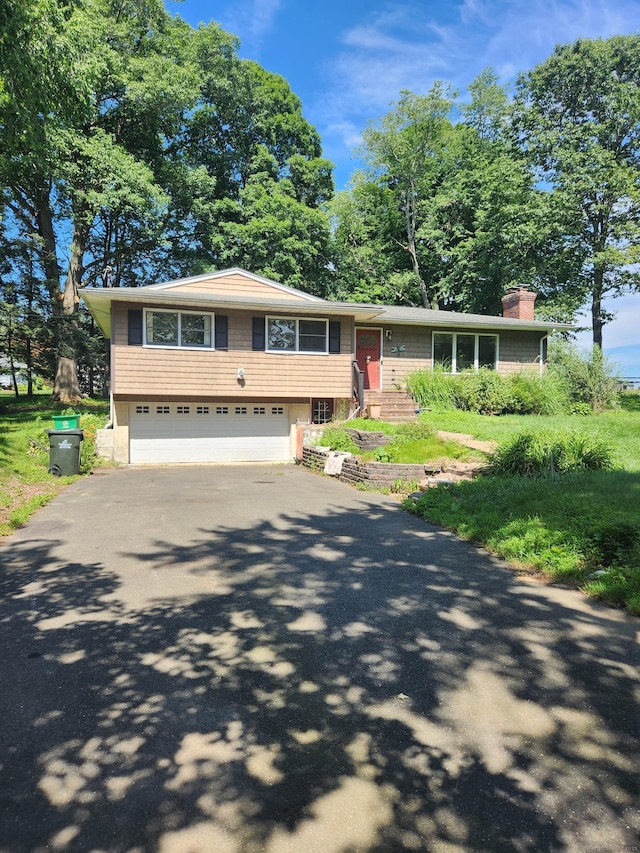 15 Juniper Rd, Newtown, CT 06470 - view of front of house with driveway, a chimney, and an attached garage