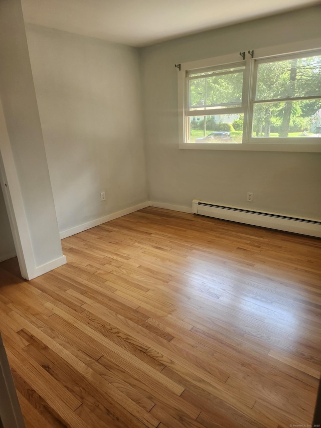 15 Juniper Rd, Newtown, CT 06470 - spare room featuring a baseboard heating unit and wood finished floors