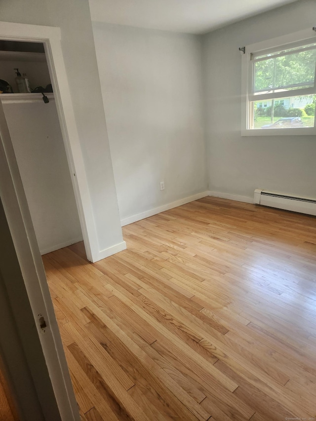 15 Juniper Rd, Newtown, CT 06470 - unfurnished bedroom featuring wood finished floors and a baseboard heating unit