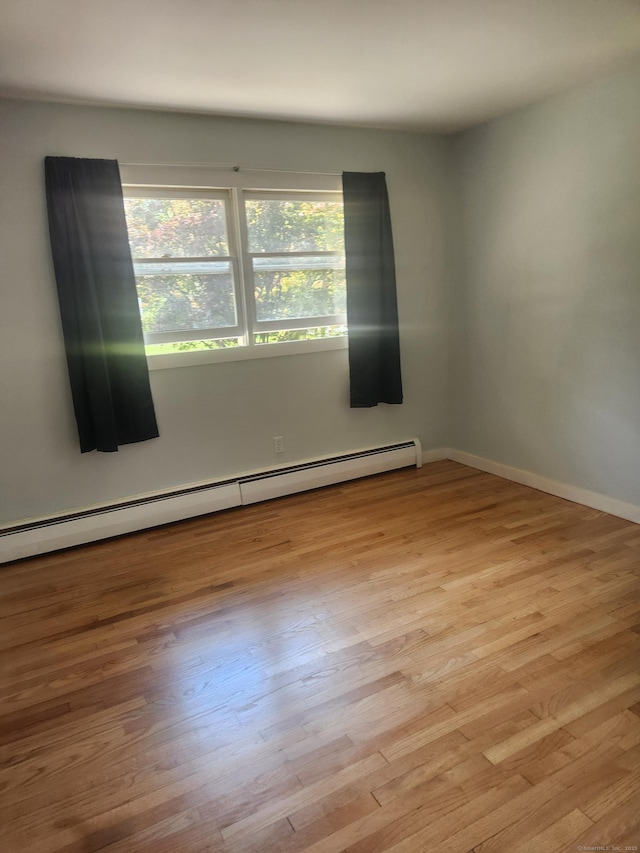 15 Juniper Rd, Newtown, CT 06470 - spare room with a baseboard heating unit and wood finished floors