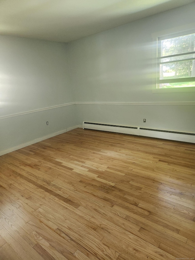 15 Juniper Rd, Newtown, CT 06470 - empty room with a baseboard heating unit and wood finished floors