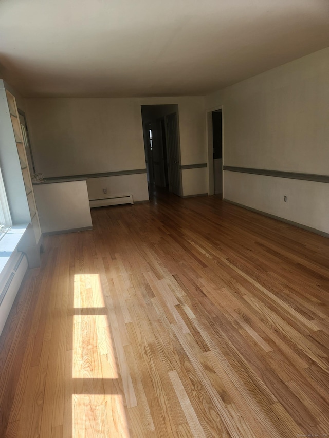 15 Juniper Rd, Newtown, CT 06470 - spare room with wood finished floors, a baseboard radiator, and a baseboard heating unit