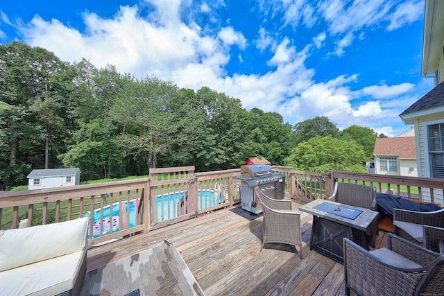 357 D Welton Way, Thomaston, CT 06787 - wooden deck with an outdoor pool, an outdoor fire pit, area for grilling, and a storage shed