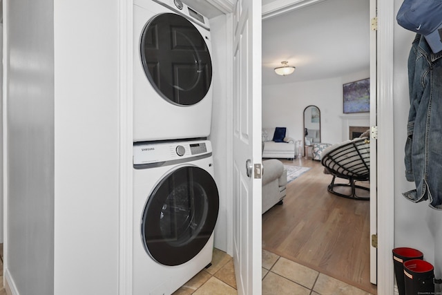 357 D Welton Way, Thomaston, CT 06787 - laundry area featuring stacked washer / dryer and light tile patterned floors
