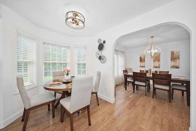357 D Welton Way, Thomaston, CT 06787 - dining space featuring arched walkways, a chandelier, and light wood finished floors