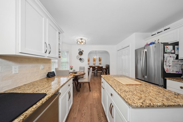 357 D Welton Way, Thomaston, CT 06787 - kitchen featuring light wood finished floors, arched walkways, tasteful backsplash, freestanding refrigerator, and white cabinets