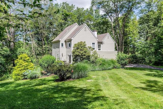 48 Deer Hill Dr, Ridgefield, CT 06877 - view of home's exterior with a lawn and a chimney