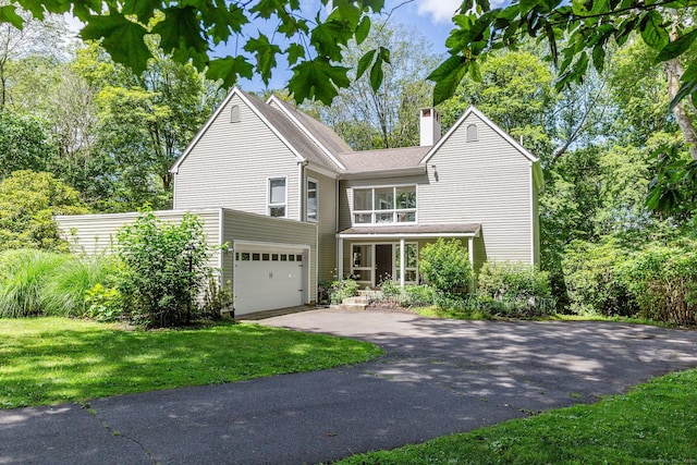 48 Deer Hill Dr, Ridgefield, CT 06877 - view of front facade with driveway, a chimney, a front yard, and a garage