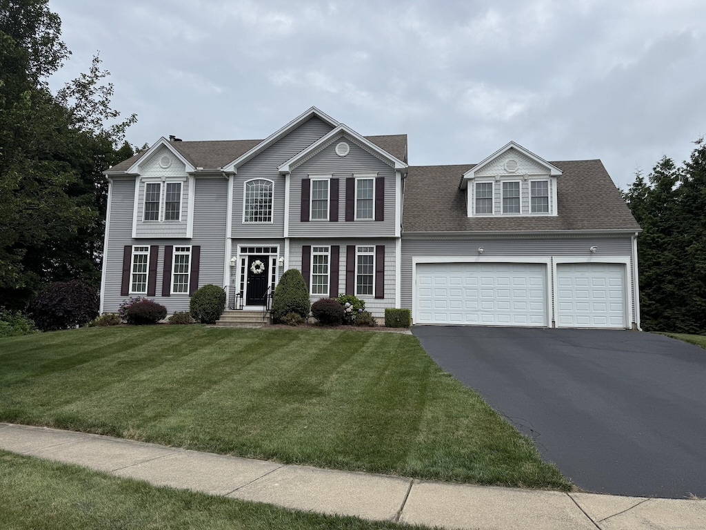 23 Falmouth Ct, Middletown, CT 06457 - view of front of home with driveway, roof with shingles, and a front lawn