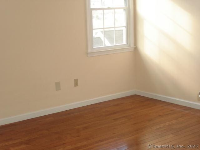55 Mill Plain Rd Unit 17-6, Danbury, CT 06811 - empty room with wood finished floors and baseboards