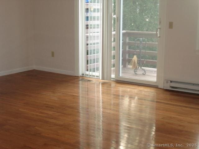 55 Mill Plain Rd Unit 17-6, Danbury, CT 06811 - empty room featuring wood finished floors and healthy amount of natural light