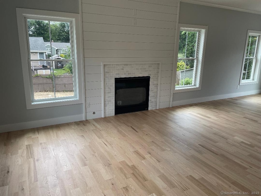 30 Bayberry Ln, Stratford, CT 06614 - unfurnished living room featuring ornamental molding, wood finished floors, and a fireplace