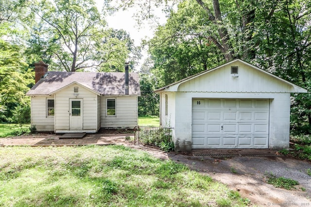 16 Oak St, New Fairfield, CT 06812 - view of front of property with an outbuilding, a detached garage, and a chimney