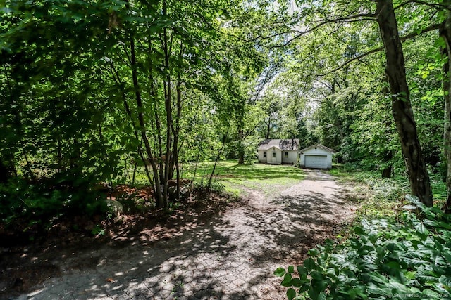 16 Oak St, New Fairfield, CT 06812 - view of yard featuring an outbuilding, a detached garage, and a forest view