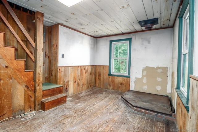 16 Oak St, New Fairfield, CT 06812 - spare room featuring wood-type flooring, stairway, wood walls, wood ceiling, and wainscoting