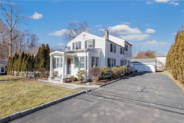 12 Sunset Ave, Trumbull, CT 06611 - traditional-style house with an outdoor structure, a detached garage, a front yard, and a chimney