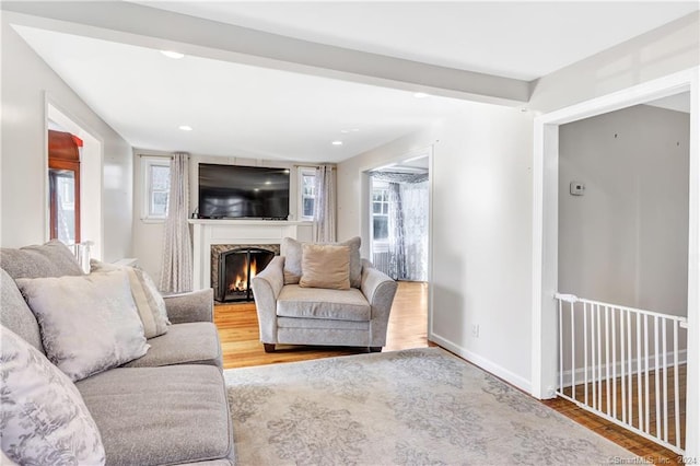 12 Sunset Ave, Trumbull, CT 06611 - living area featuring wood finished floors, a lit fireplace, and recessed lighting