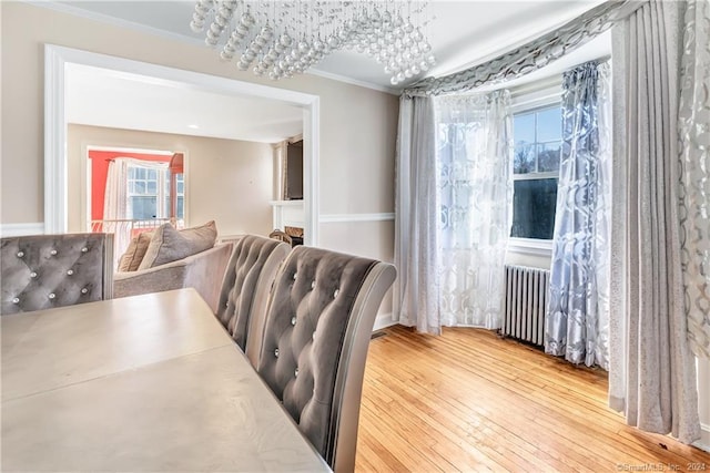 12 Sunset Ave, Trumbull, CT 06611 - dining space featuring ornamental molding, wood-type flooring, and radiator heating unit