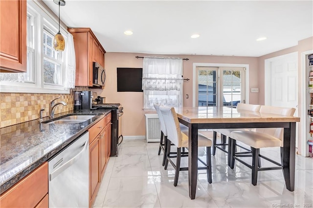 12 Sunset Ave, Trumbull, CT 06611 - kitchen with brown cabinets, stainless steel appliances, light marble finish flooring, decorative backsplash, and dark stone counters