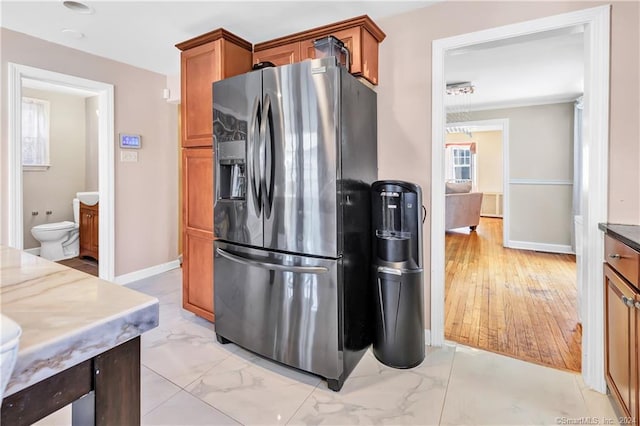 12 Sunset Ave, Trumbull, CT 06611 - kitchen featuring stainless steel fridge, light marble finish flooring, and brown cabinets