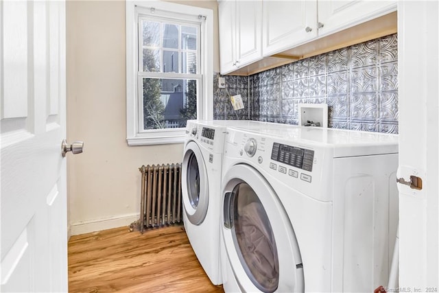 12 Sunset Ave, Trumbull, CT 06611 - laundry room with washing machine and clothes dryer, radiator heating unit, light wood finished floors, and cabinet space
