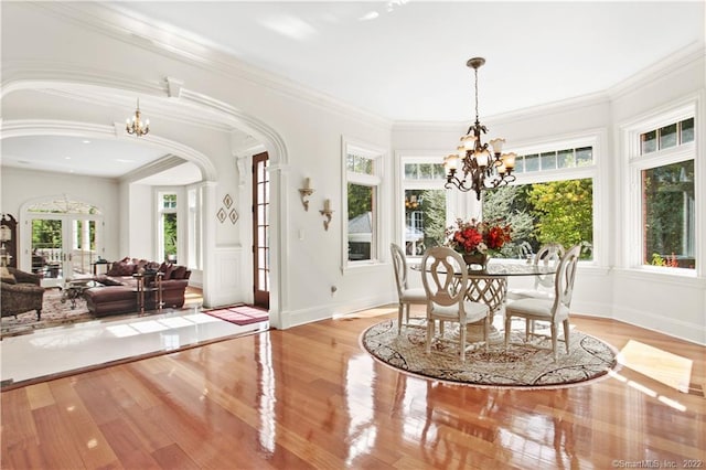 interior space with a healthy amount of sunlight, light hardwood / wood-style floors, and an inviting chandelier