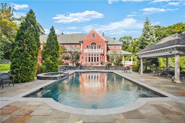 view of pool with a gazebo, an in ground hot tub, and a patio