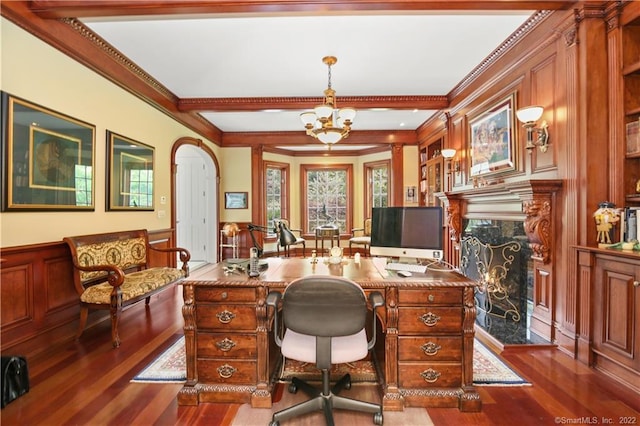 office featuring a chandelier, a high end fireplace, dark wood-type flooring, and crown molding