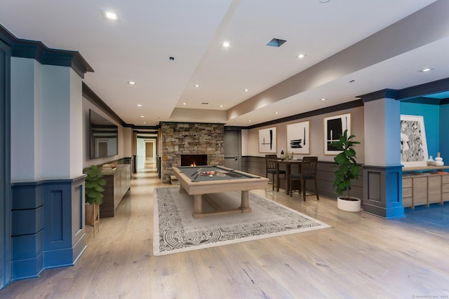 recreation room with a wainscoted wall, pool table, light wood-style floors, and ornamental molding