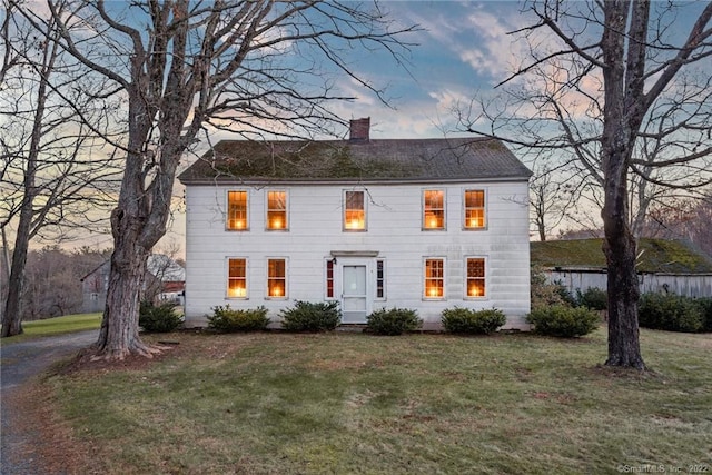 colonial-style house with a yard