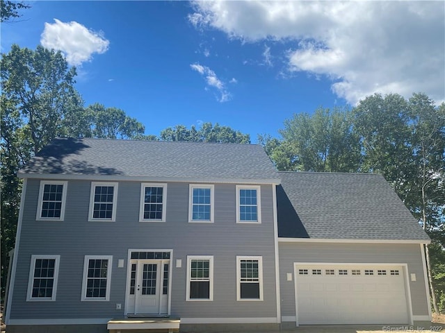 colonial inspired home featuring a garage