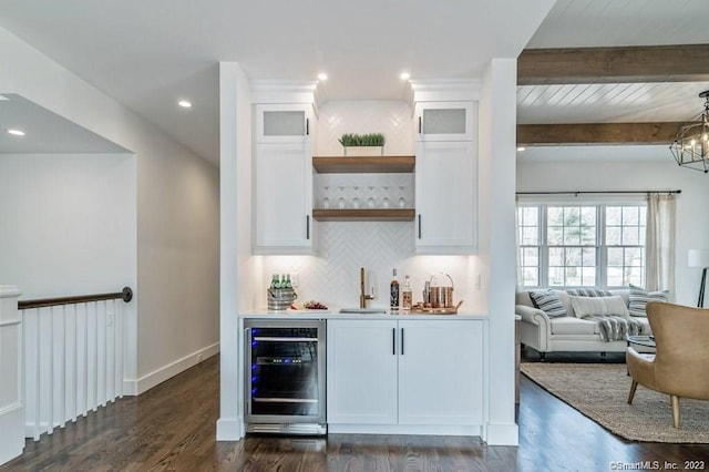 bar with a notable chandelier, beam ceiling, wine cooler, white cabinetry, and dark hardwood / wood-style floors