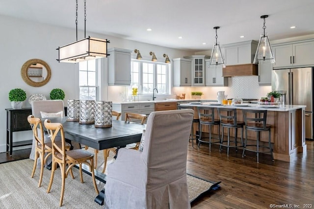 dining area with sink and dark hardwood / wood-style flooring