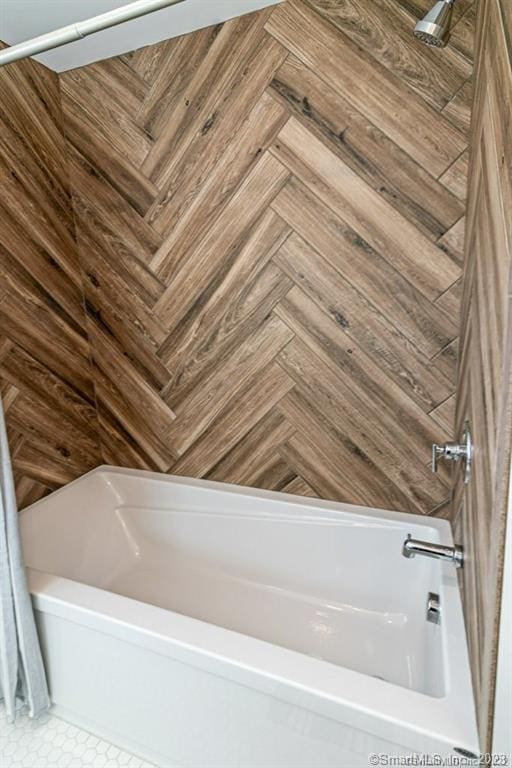 bathroom with parquet floors and tub / shower combination