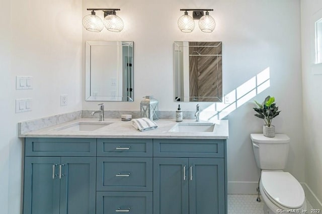 bathroom featuring tile flooring, double vanity, and toilet