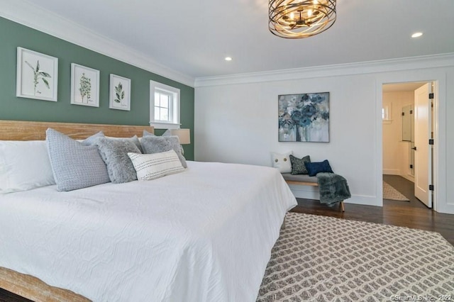 bedroom with a chandelier, dark wood-type flooring, and crown molding