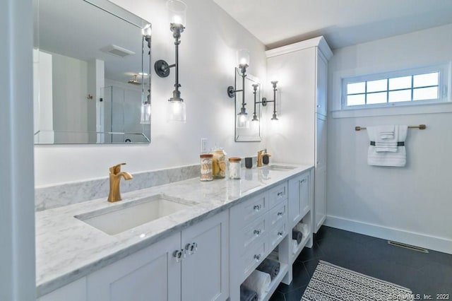 bathroom featuring oversized vanity, tile floors, and dual sinks