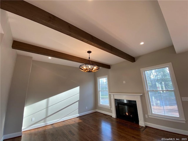 unfurnished living room with a notable chandelier, dark wood-type flooring, and beamed ceiling