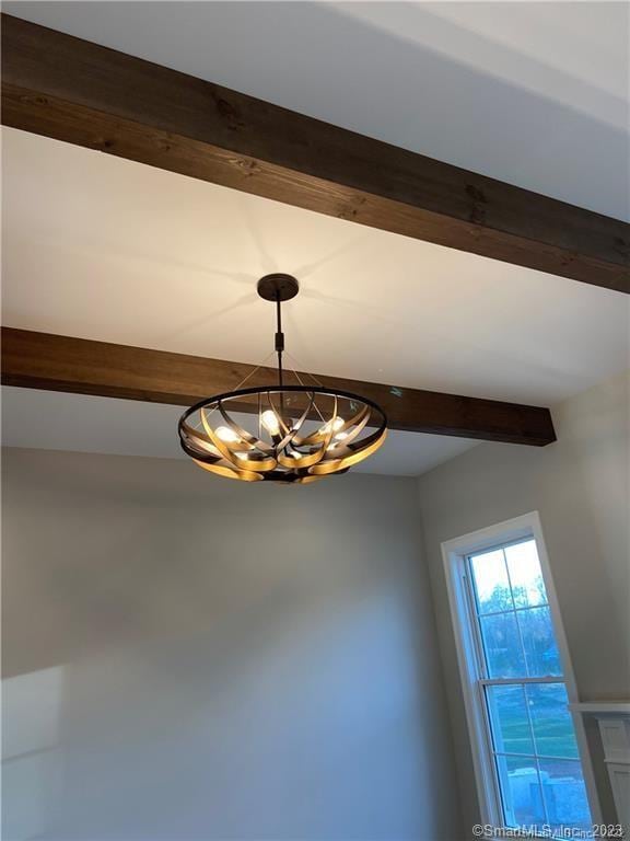 interior details with an inviting chandelier and beam ceiling