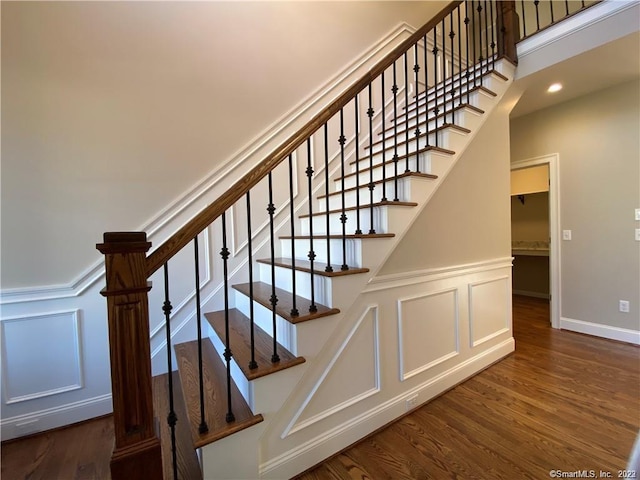 staircase featuring dark hardwood / wood-style flooring