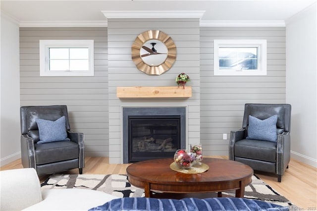 living room with light wood-type flooring and ornamental molding