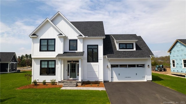 modern farmhouse with a front lawn and a garage