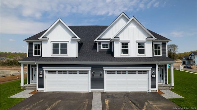 view of front of home featuring a front lawn and a garage