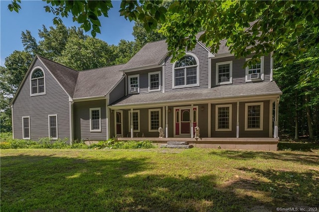 view of front facade with a front yard and covered porch