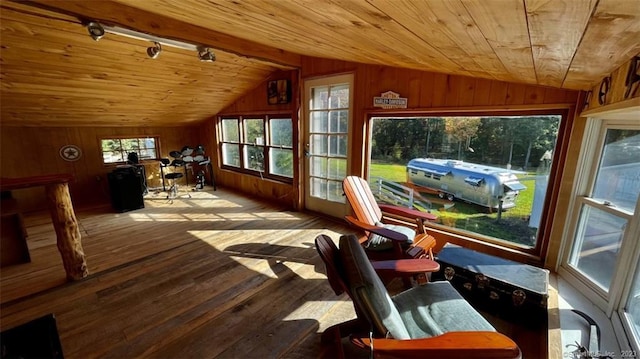 sunroom with lofted ceiling, wooden ceiling, and track lighting