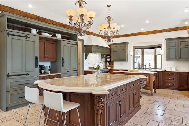 kitchen featuring light tile flooring, pendant lighting, a kitchen island, and a chandelier