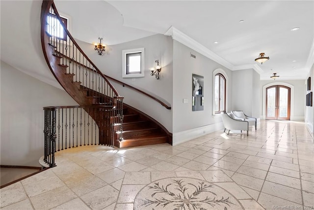 interior space with crown molding, french doors, light tile floors, and a towering ceiling