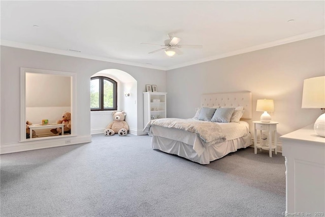 carpeted bedroom with crown molding and ceiling fan