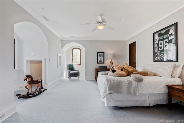 carpeted bedroom with ceiling fan and ornamental molding