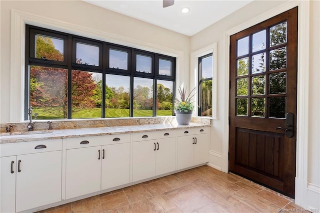 interior space featuring sink and light tile flooring